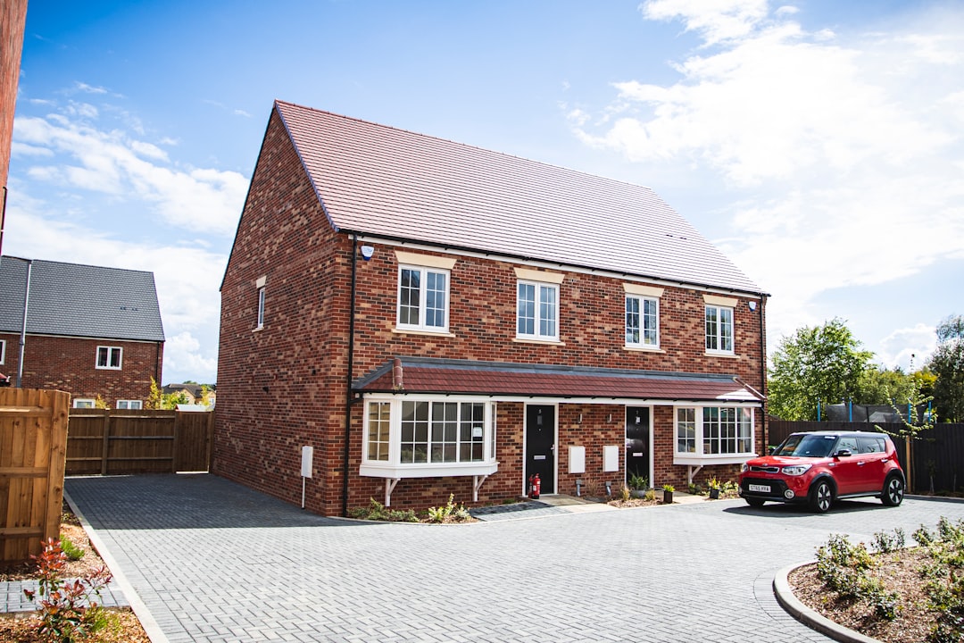 brown brick house under blue sky during daytime